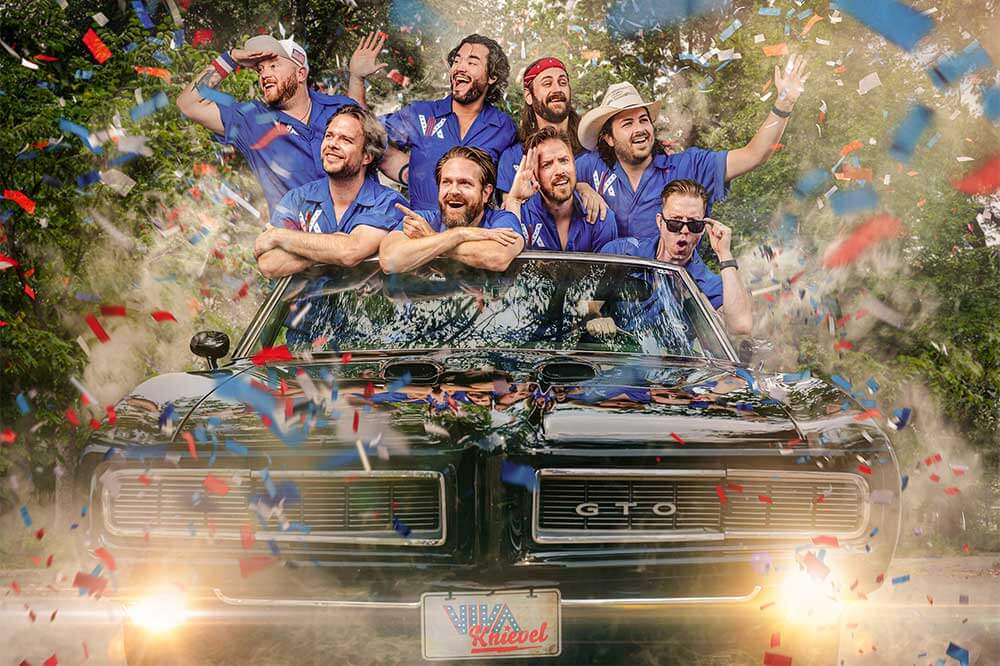 Photo of Viva Knievel band hanging out the top of a convertible